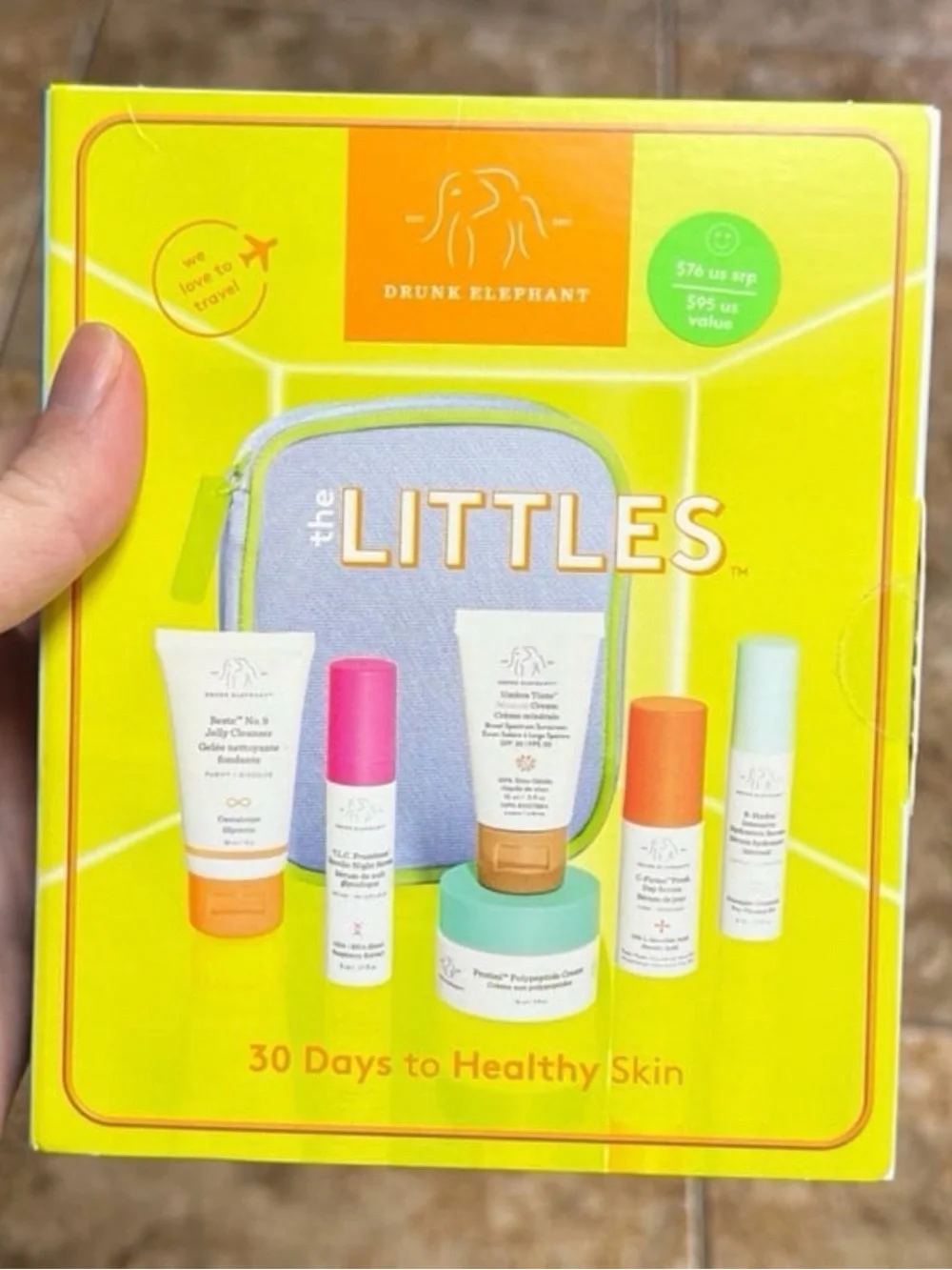Drunk Elephant travel skincare set in yellow, purple & mint accents